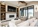 Cozy living room with a stone fireplace, built-in shelving, and a large sliding glass door to the outside at 4292 Alderborough Way, Zionsville, IN 46077
