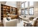 Spacious living room showcasing custom cabinets, tall windows, and a comfortable seating arrangement at 4292 Alderborough Way, Zionsville, IN 46077