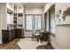 Bright office with wooden floors, built-in shelves, a cowhide rug, and three windows at 4292 Alderborough Way, Zionsville, IN 46077