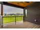 Covered patio overlooking green fields, houses, and trees, brick pillars and railings at 4292 Alderborough Way, Zionsville, IN 46077