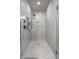 Modern shower with glass door, white marble tile, and sleek fixtures, offering a luxurious and spa-like experience at 4292 Alderborough Way, Zionsville, IN 46077