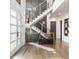 Modern staircase with light hardwood steps and a black metal railing leading to the second floor at 4292 Alderborough Way, Zionsville, IN 46077