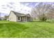 Generous backyard featuring a screened-in porch, lush lawn, and mature trees, creating a serene and private outdoor oasis at 5288 Ivy Hill Dr, Carmel, IN 46033