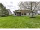 Spacious backyard featuring a screened-in porch, lush lawn, and mature trees, offering ample space for outdoor activities at 5288 Ivy Hill Dr, Carmel, IN 46033
