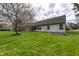 Expansive backyard featuring a screened-in porch, lush lawn, and mature trees perfect for relaxation and outdoor enjoyment at 5288 Ivy Hill Dr, Carmel, IN 46033