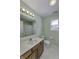 Bright bathroom featuring a single sink vanity, a mirror with lights, and a toilet at 5288 Ivy Hill Dr, Carmel, IN 46033