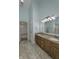 This primary bathroom offers a double sink vanity with granite counters and tile flooring at 5288 Ivy Hill Dr, Carmel, IN 46033