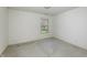 This bedroom has neutral colored walls and carpet, with a window view to the yard at 5288 Ivy Hill Dr, Carmel, IN 46033