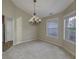 Bright dining area featuring a chandelier, ample natural light from two windows, and neutral decor at 5288 Ivy Hill Dr, Carmel, IN 46033