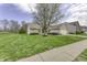 Charming single-story home featuring brick and vinyl siding with a well-manicured lawn and attached two-car garage at 5288 Ivy Hill Dr, Carmel, IN 46033