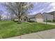 Charming single-story home featuring brick and vinyl siding with a well-manicured lawn and attached two-car garage at 5288 Ivy Hill Dr, Carmel, IN 46033