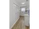 Bright laundry room features wood-look floors, storage shelves, and a convenient water softener system at 5288 Ivy Hill Dr, Carmel, IN 46033