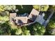 Aerial perspective reveals a large home with a sprawling patio, driveway, and beautiful, mature landscaping at 5528 State Road 144, Greenwood, IN 46143