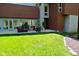 Manicured backyard of a residence highlighting a paved patio and lush, green lawn at 5528 State Road 144, Greenwood, IN 46143