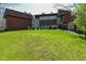 Expansive backyard featuring lush green grass and mature trees surrounding the property at 5528 State Road 144, Greenwood, IN 46143