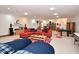 Spacious basement living room features neutral carpet, a comfortable sectional sofa, and cozy decor for relaxing and entertaining at 5528 State Road 144, Greenwood, IN 46143