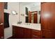 Bathroom with sleek vanity, undermount sink, quartz countertops, and a modern mirror at 5528 State Road 144, Greenwood, IN 46143