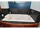 Relaxing bathroom featuring a soaking tub with black slate surround, ideal for unwinding after a long day at 5528 State Road 144, Greenwood, IN 46143
