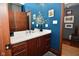 Chic bathroom with bright blue walls, decorative vanity, and stylish fixtures at 5528 State Road 144, Greenwood, IN 46143