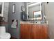 Cozy bathroom featuring modern vanity with stone countertop and LED lighted mirror with gray accent walls at 5528 State Road 144, Greenwood, IN 46143