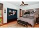 Luxurious bedroom featuring a stone accent wall, platform bed, and modern ceiling fan for ultimate comfort at 5528 State Road 144, Greenwood, IN 46143