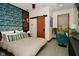 Comfortable bedroom featuring a bed, window for lots of sunlight, desk area and contemporary sliding door at 5528 State Road 144, Greenwood, IN 46143