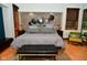 Comfortable bedroom featuring a stone accent wall, platform bed, and stylish wooden framed windows at 5528 State Road 144, Greenwood, IN 46143