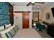Stylish bedroom featuring a sliding barn door, cozy seating area, and unique decorative accents at 5528 State Road 144, Greenwood, IN 46143