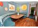Charming breakfast nook with a unique curved bench and decorative lighting, perfect for casual dining and relaxation at 5528 State Road 144, Greenwood, IN 46143