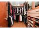 Organized walk-in closet with ample hanging space, shelving, and shoe racks for wardrobe storage at 5528 State Road 144, Greenwood, IN 46143