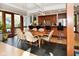 Open dining area with dark tile flooring, stylish furniture, and natural light, adjacent to the kitchen at 5528 State Road 144, Greenwood, IN 46143