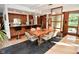 An open-concept dining room with modern lighting, wood accents, and views to the outside enhances the dining experience at 5528 State Road 144, Greenwood, IN 46143