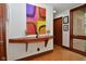 Inviting entryway featuring a stylish wood console table, decorative artwork, and bright window at 5528 State Road 144, Greenwood, IN 46143