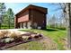 Modern architectural home design with large rocks, three-car garage, and a beautifully landscaped yard at 5528 State Road 144, Greenwood, IN 46143