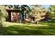 Attractive exterior featuring modern design, large windows, and vibrant landscaping in a wooded area at 5528 State Road 144, Greenwood, IN 46143