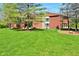 Charming front exterior view highlighting modern design elements and beautifully maintained green space in a wooded area at 5528 State Road 144, Greenwood, IN 46143