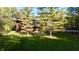 Beautiful front exterior view with well-manicured lawn, mature trees and attractive landscaping in a wooded area at 5528 State Road 144, Greenwood, IN 46143