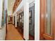 Bright hallway with hardwood floors and decorative lighting, showcasing artwork at 5528 State Road 144, Greenwood, IN 46143