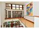 Bright hallway with hardwood floors, stainless steel railings and lots of windows offering an abundance of natural light at 5528 State Road 144, Greenwood, IN 46143