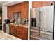 Modern kitchen with stainless steel appliances, wooden cabinetry, and granite countertops offers a sleek and functional cooking space at 5528 State Road 144, Greenwood, IN 46143