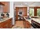 A gourmet kitchen offers granite countertops, stainless steel appliances, and seamlessly connects to a built-in desk area at 5528 State Road 144, Greenwood, IN 46143