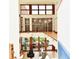 Upstairs view of the living room showcasing its high ceilings, expansive windows, and contemporary design at 5528 State Road 144, Greenwood, IN 46143