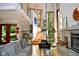 Bright living room with high ceilings, a stone fireplace, hardwood floors and large windows, offering natural light at 5528 State Road 144, Greenwood, IN 46143