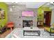 Bright living area showcases a stone fireplace, modern decor, and a comfortable seating arrangement for a stylish and inviting space at 5528 State Road 144, Greenwood, IN 46143