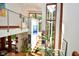 Bright, open staircase area with modern railings and large windows showcasing the home's natural surroundings at 5528 State Road 144, Greenwood, IN 46143