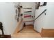 Staircase with wooden steps and a decorative wall showcasing art pieces, adding a touch of style and sophistication at 5528 State Road 144, Greenwood, IN 46143