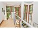 Staircase landing featuring modern lighting fixtures and expansive windows with views at 5528 State Road 144, Greenwood, IN 46143