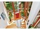 Unique staircase with wood trim and large windows showcasing green outdoor scenery and sunlight at 5528 State Road 144, Greenwood, IN 46143