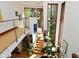 Bright, open staircase area with contemporary railings and large windows showcasing nature views at 5528 State Road 144, Greenwood, IN 46143