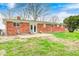 Brick home featuring a backyard with a patio and green lawn at 5541 S County Road 150 E, Clayton, IN 46118